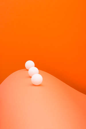 Abstract with white balls and sheets of colored paperの写真素材