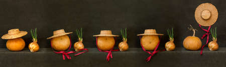 Still life with pumpkins, hats and sprouted onions on the table