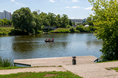 Belgorod, Russia - July 08, 2021: Boat skating along the Vezelka River in Victory Park in Belgorod