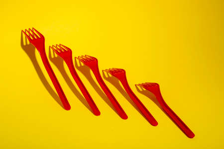Abstract still life with red forks on a colored backgroundの写真素材