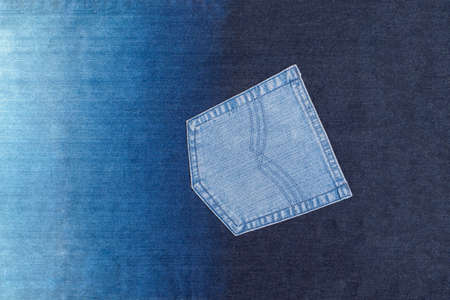 Background of genuine denim with sewn pocketの写真素材