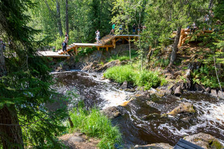 Ruskeala, Russia - July 10, 2021: People at Ruskeala waterfalls on the Tohmayoki river in the Republic of Karelia in Russiaのeditorial素材