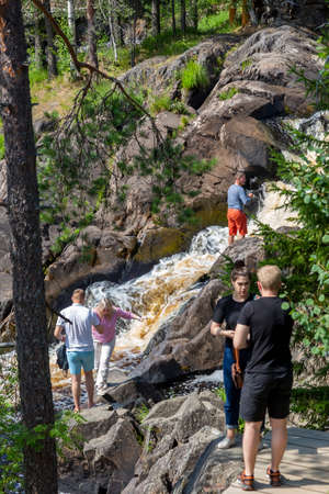 Ruskeala, Russia - July 10, 2021: People at Ruskeala waterfalls on the Tohmayoki river in the Republic of Karelia in Russiaのeditorial素材