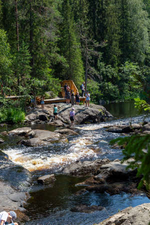 Ruskeala, Russia - July 10, 2021: People at Ruskeala waterfalls on the Tohmayoki river in the Republic of Karelia in Russiaのeditorial素材