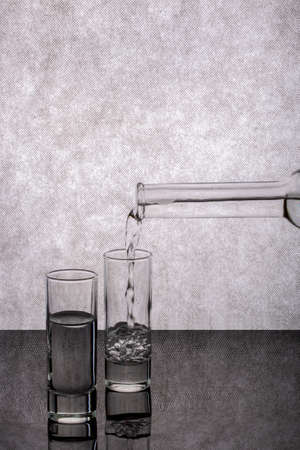 Still life with pouring liquid into a glassの写真素材