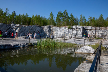 Ruskeala, Russia - July 10, 2021: People inspect the marble mining site in the Marble Canyon in Ruskeala in the Republic of Karelia in Russiaのeditorial素材