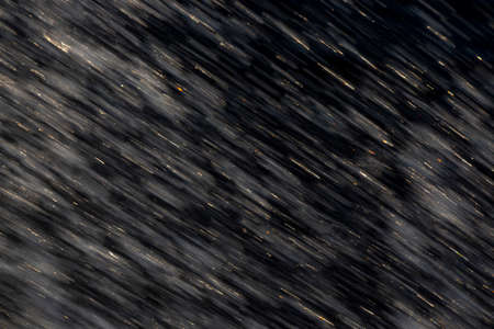 Abstract background of flying water droplets on a dark backgroundの写真素材