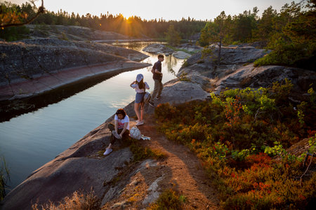 Sortavala, Russia - July 10, 2021: People inspect the nature of the skerries on Lake Ladoga in the Republic of Karelia in Russia at sunsetのeditorial素材