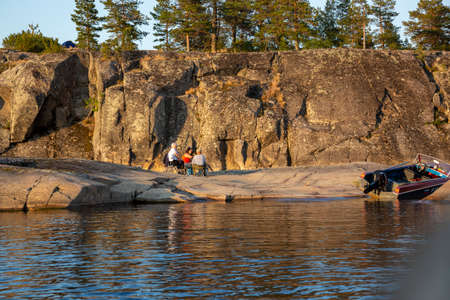 Sortavala, Russia - July 10, 2021: People rest on a skerry on Lake Ladoga in the Republic of Karelia in Russiaのeditorial素材