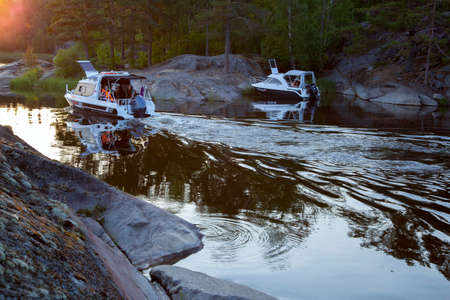 Sortavala, Russia - July 10, 2021: Tourists travel on engine boats on Skerry in Lake Ladoga in Russiaのeditorial素材