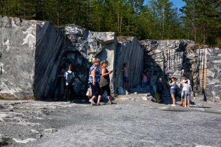 Ruskeala, Russia - July 10, 2021: People inspect the marble mining site in the Marble Canyon in Ruskeala in the Republic of Karelia in Russiaのeditorial素材