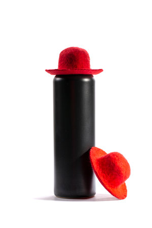 Still life with a black bottle and two red wool hatsの写真素材