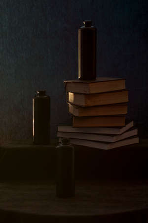 Still life with books and black bottlesの写真素材