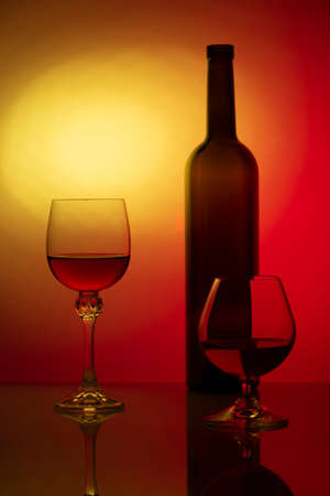 Still life with glass bottle and wine glasses