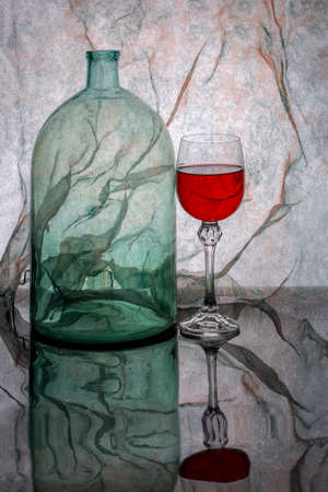 Still life with a glass jar and a glass of red wine.の写真素材
