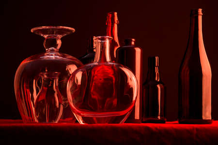 Still life with glass dishes on the red tableの写真素材
