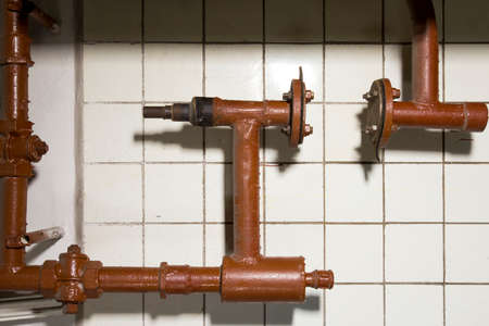 Fragment of a pipeline with cranes and connections on a tile backgroundの写真素材