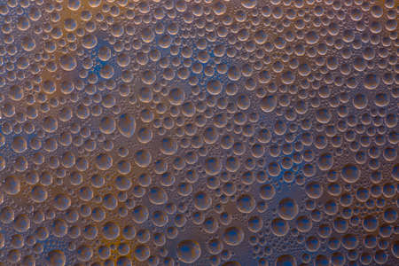 Abstract background of water droplets on the glass surfaceの写真素材