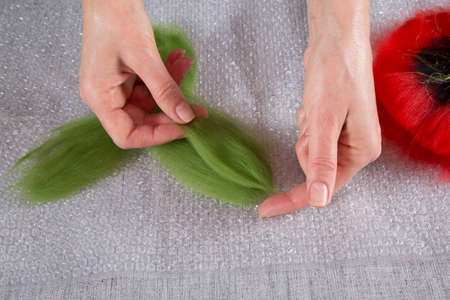 Women's hands lay out the wool in the process of creating a product