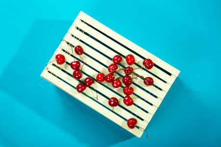Ripe red cherries on a wooden boxの写真素材