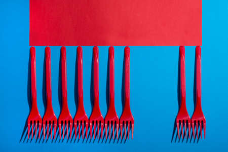 Abstract still life with red forks on a colored backgroundの写真素材