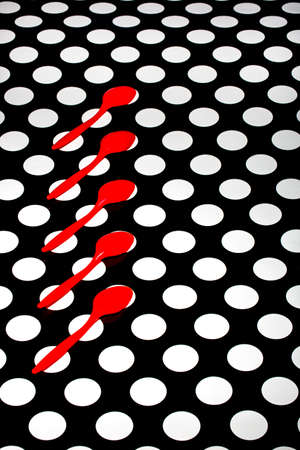 Abstract still life with red spoons on a black and white background