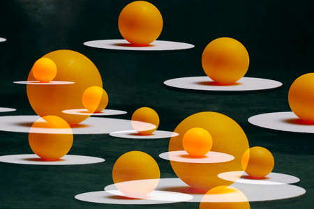 Abstract still life with orange balls on white sands suspended in the air