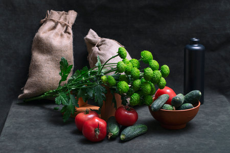 Still life with tomatoes, cucumbers and a bouquet of chrysanthemumsの写真素材