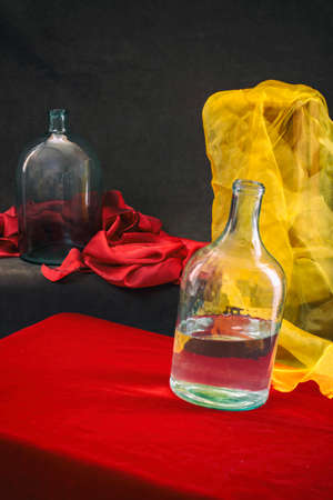 Still life with glass jars and yellow and red fabricの写真素材