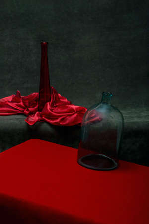 Still life with a red bottle and a glass jarの写真素材