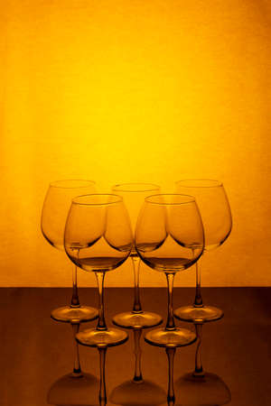 Still life with empty wine glasses on a reflective surfaceの写真素材