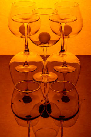 Still life with empty wine glasses on a reflective surfaceの写真素材
