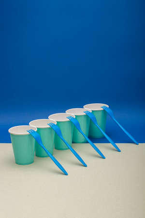 Abstract still life with blue forks and paper cupsの写真素材