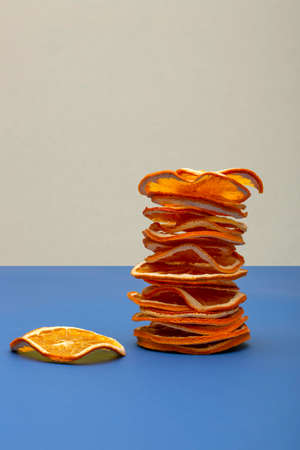 A stack of dried orange slices on a colored background