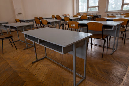 A fragment of the interior of the classroom with desks in an educational institutionの写真素材