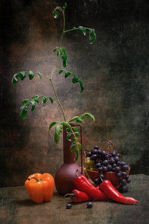 Tomato seedling with pepper, fruit and a bunch of grapesの写真素材