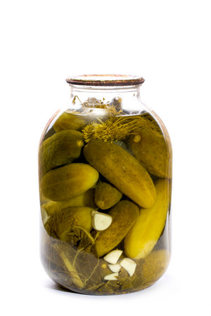 Glass jar with canned cucumbers on a white backgroundの写真素材