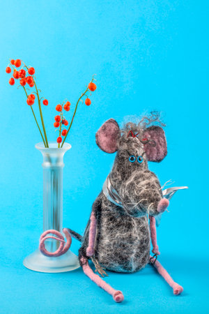 Rat - soft toy made of felted wool on a blue backgroundの写真素材