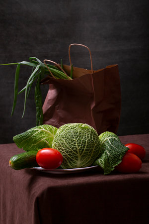 Still life with Savoy cabbage, cucumber, red tomatoes and onionの写真素材