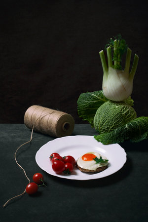 Steak with egg and tomatoes, savoy cabbage and fennelの写真素材