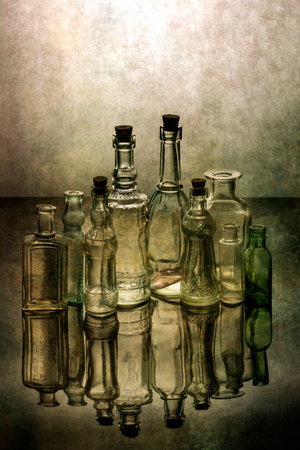 Still life with old glass bottles with reflectionの写真素材