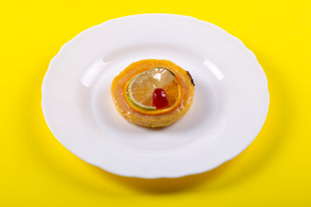 Cheese cake with marmalade and lime and orange slices