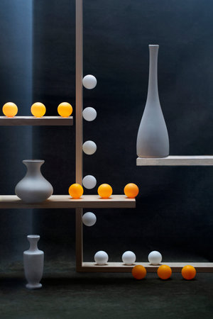 Geometric still life with white and orange balls and white vasesの写真素材