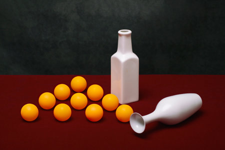 Still life with white vases and orange ballsの写真素材