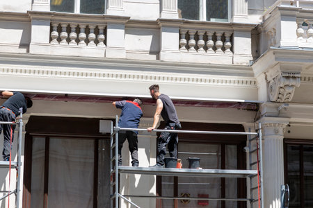 Vienna, Austria - June 13, 2023: Builders in the process of restoring the facade of the building.のeditorial素材