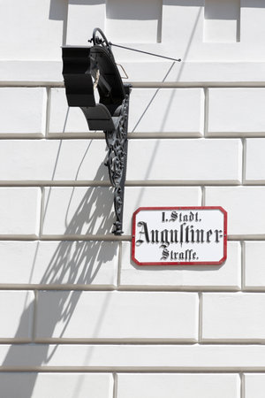 Vienna, Austria - June 13, 2023: A sign with the name of the Augustinerstrasse street in Gothic script in the center of Viennaのeditorial素材