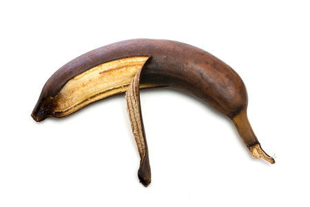 Brown overripe banana on a white backgroundの写真素材