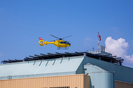 Vienna, Austria - June 14, 2023: An ambulance helicopter lands on the roof of the Donaustadt Clinic building in Viennaのeditorial素材