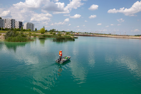 Vienna, Austria - June 14, 2023: A man is sailing on a boat on Lake Asperger in Viennaのeditorial素材