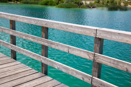 Wooden platform and fence on the river bankの写真素材